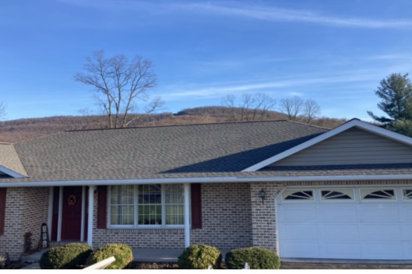 A new roof installed on a brick house by a local roofing company